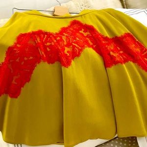 100% pure silk  ocher siena Karven skirt with red lace decor. Cut half skirt